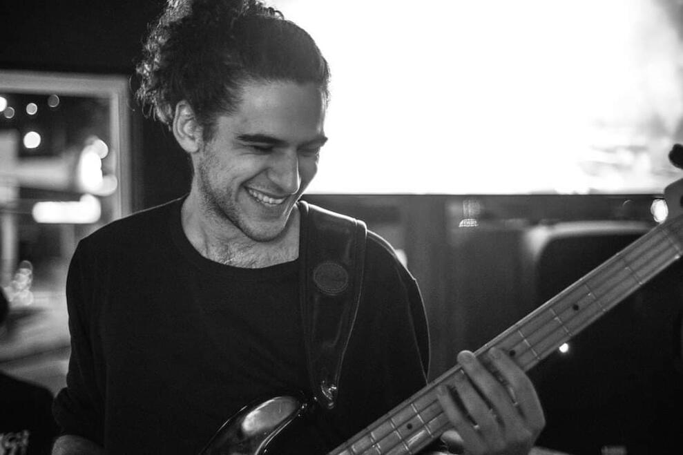 Untitled Elias Kokkoris performing on a Fender Jazz USA electric bass with Jay Devu, black and white photo, shot at Last Night on Earth, Southport.