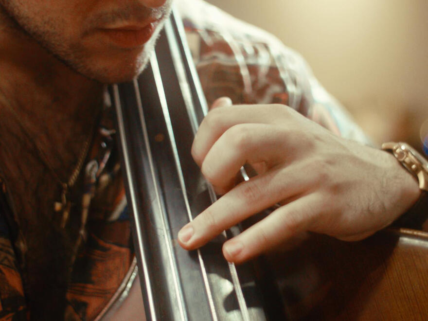 Untitled Close-up of Elias Kokkoris's left hand and double bass fingerboard, improvising in response to a live painter's artwork. Photo by Luis Campbell.